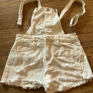 White ripped jean overalls